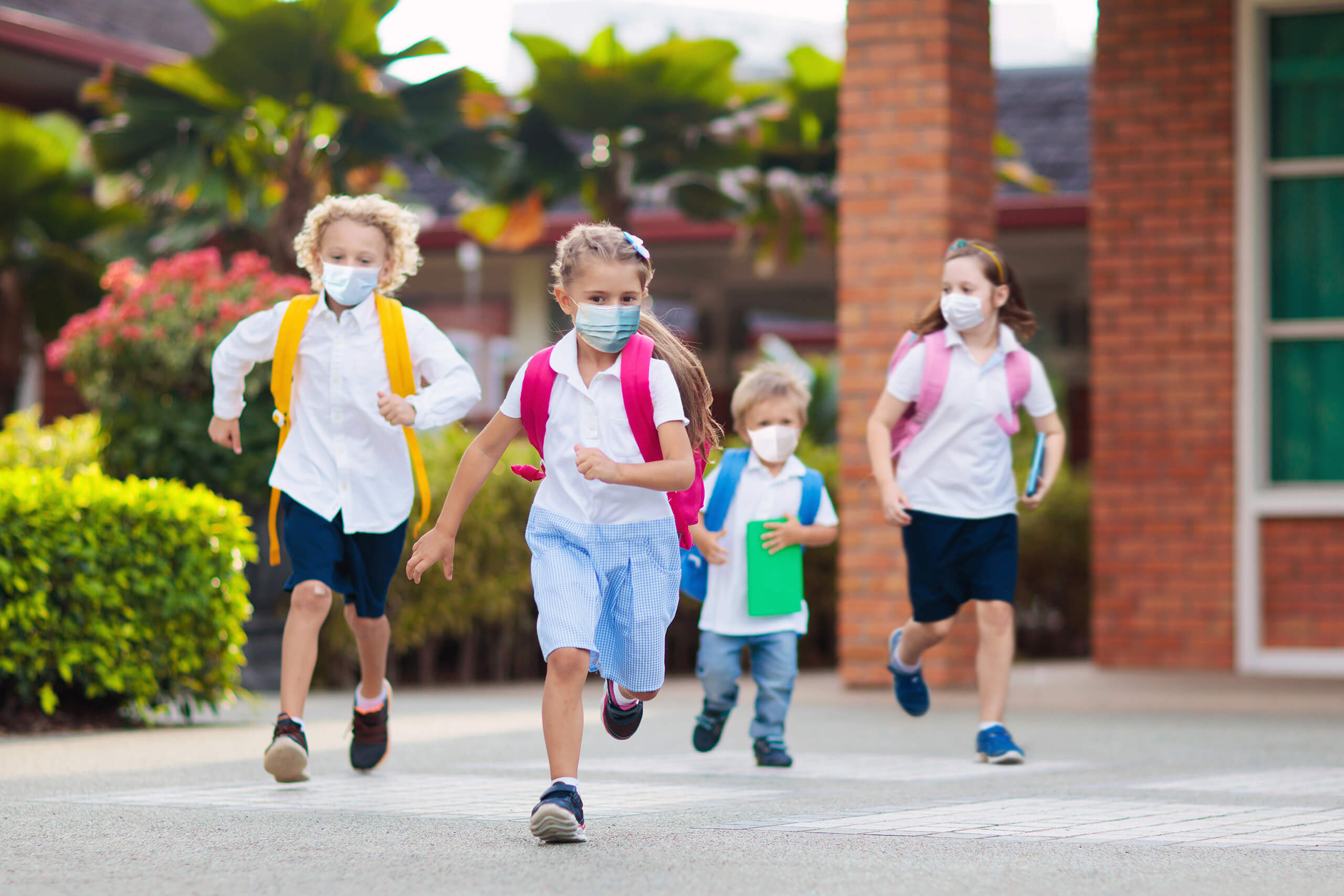 Boy and girl going back to school after covid-19 quarantine and lockdown